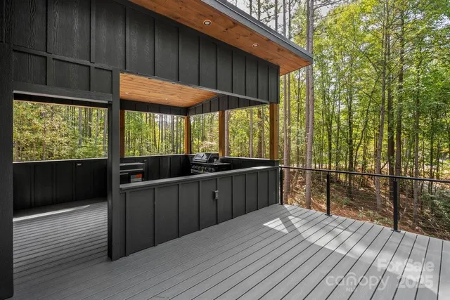 a view of a balcony with wooden floor and fence