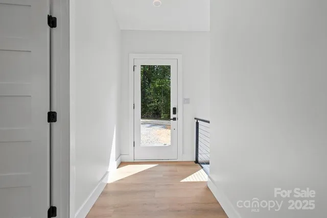 an empty room with wooden floor and a window