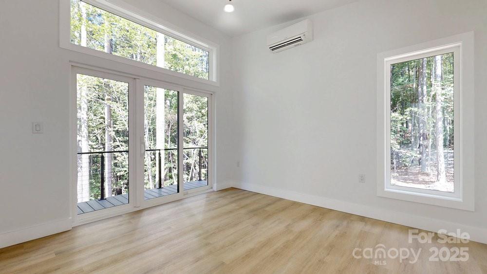 203 Golden Crk Ridge Union Mills, NC 28167 - Photo 20 of 47 a view of an empty room with wooden floor and a window