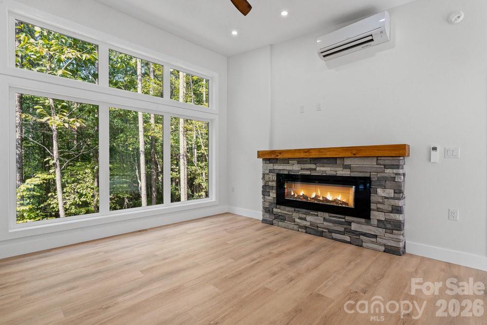 203 Golden Crk Ridge Union Mills, NC 28167 - Photo 24 of 47 a view of an empty room with wooden floor fireplace and a window
