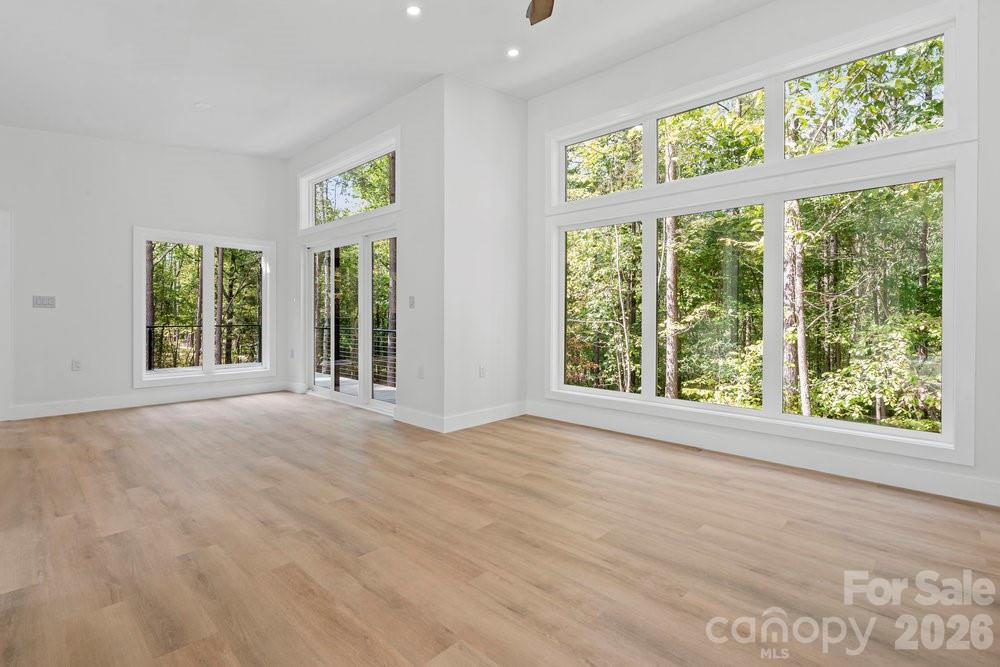 203 Golden Crk Ridge Union Mills, NC 28167 - Photo 25 of 47 a view of an empty room with wooden floor and windows
