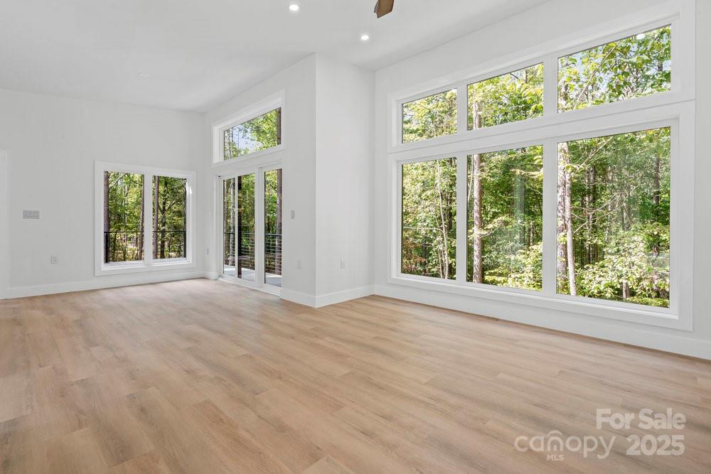 203 Golden Crk Ridge Union Mills, NC 28167 - Photo 25 of 47 a view of an empty room with wooden floor and windows