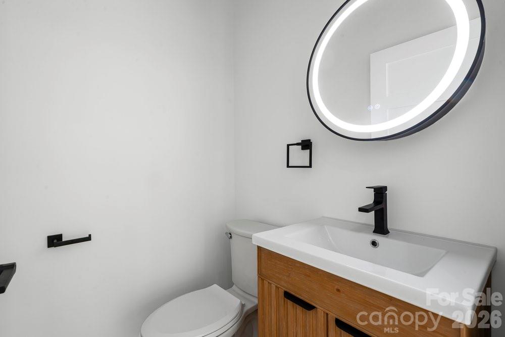 203 Golden Crk Ridge Union Mills, NC 28167 - Photo 26 of 47 a bathroom with a sink a mirror and toilet