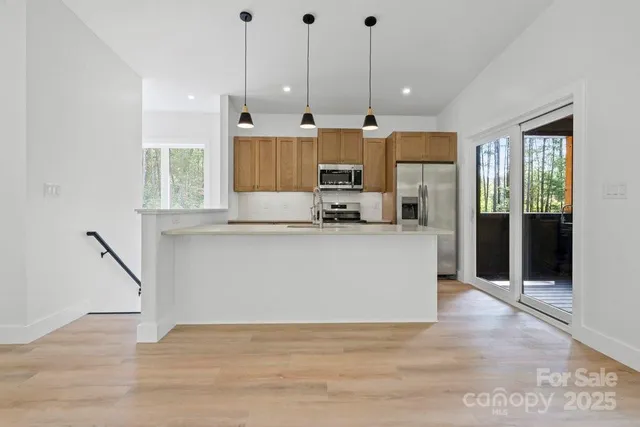 a kitchen with a sink window and cabinets