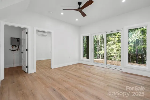 a living room with furniture a large window and a flat screen tv