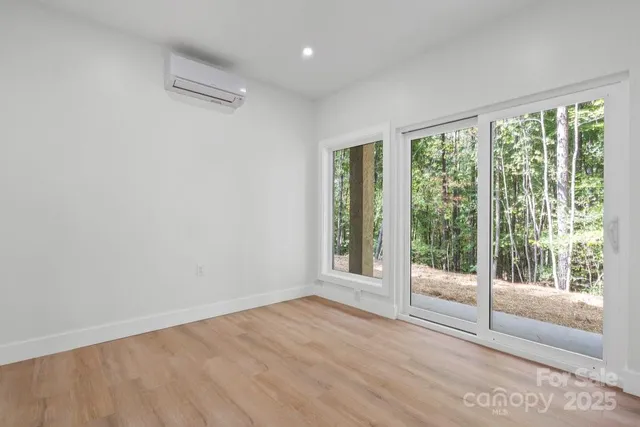a bedroom with bed and large window