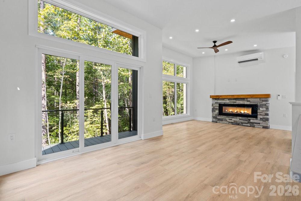 203 Golden Crk Ridge Union Mills, NC 28167 - Photo 7 of 47 an empty room with windows fireplace and outdoor view