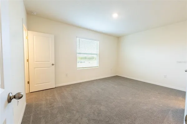 an empty room with a empty space and windows