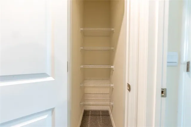 a walk in closet with a white paint