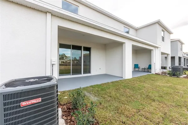 a view of an house with backyard space and balcony