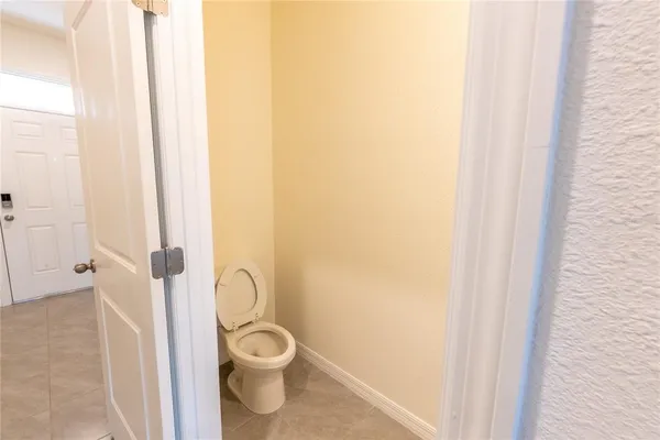 a bathroom with a toilet and a shower curtain