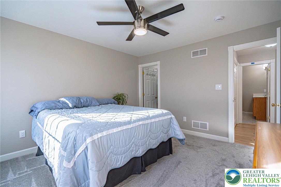 6551 Overlook Road Orefield, PA 18069 - Photo 54 of 82 a bedroom with a bed and a chandelier
