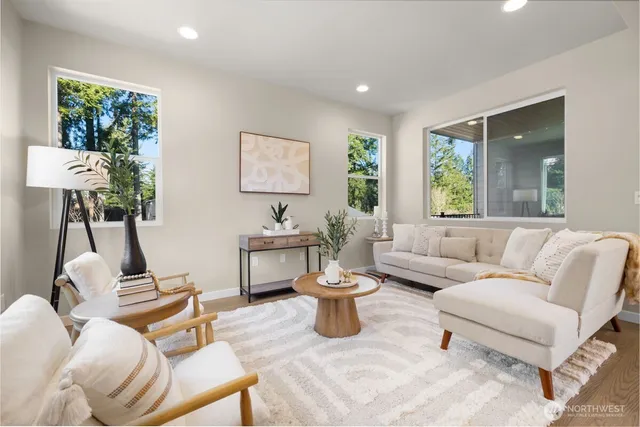 a living room with furniture a window and a lamp