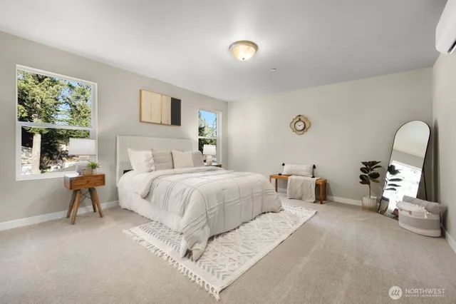 a bedroom with a bed a mirror and a window