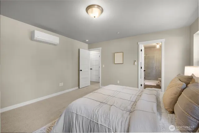 a bedroom with a bed and a lamp