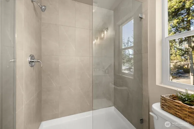 a bathroom with a granite countertop shower a sink and a toilet