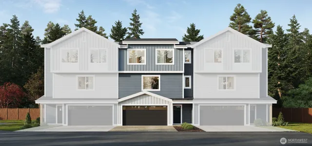 a front view of a white house with a yard