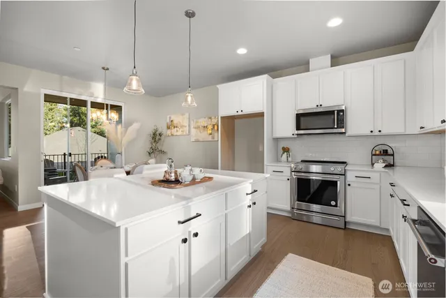 a kitchen with a sink a stove a refrigerator and cabinets