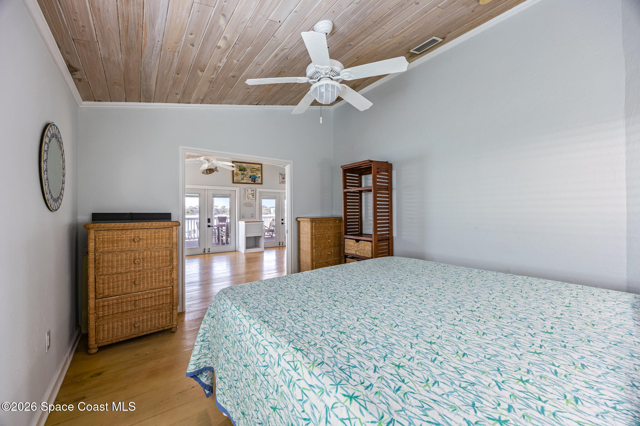 25 Vip Island, Unit A Grant, FL 32949 - Photo 13 of 56 a bedroom with a bed and a chandelier