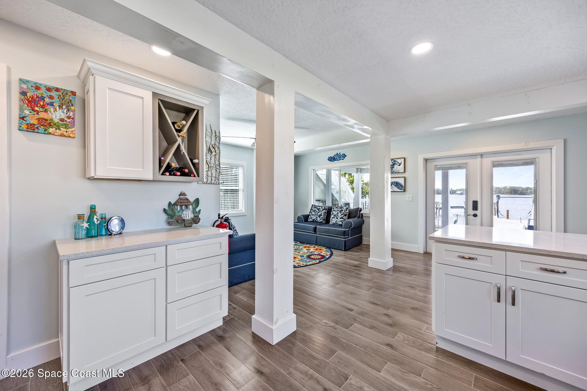 25 Vip Island, Unit A Grant, FL 32949 - Photo 19 of 56 a kitchen with white cabinets and wooden floor