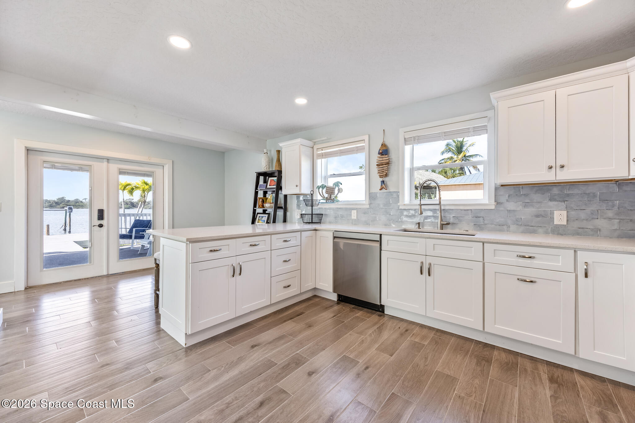 25 Vip Island, Unit A Grant, FL 32949 - Photo 21 of 56 a kitchen with white cabinets sink and white appliances