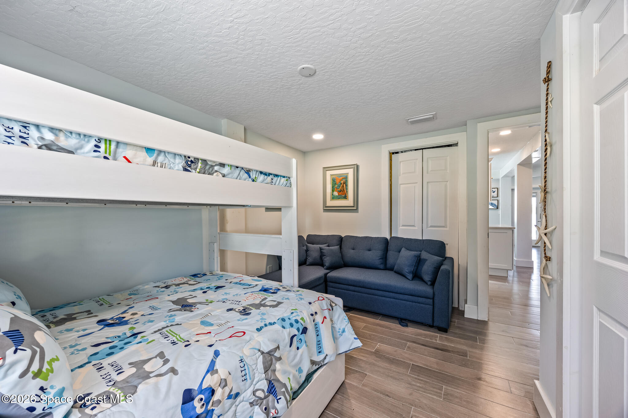 25 Vip Island, Unit A Grant, FL 32949 - Photo 26 of 56 a bedroom with a bed and a couch