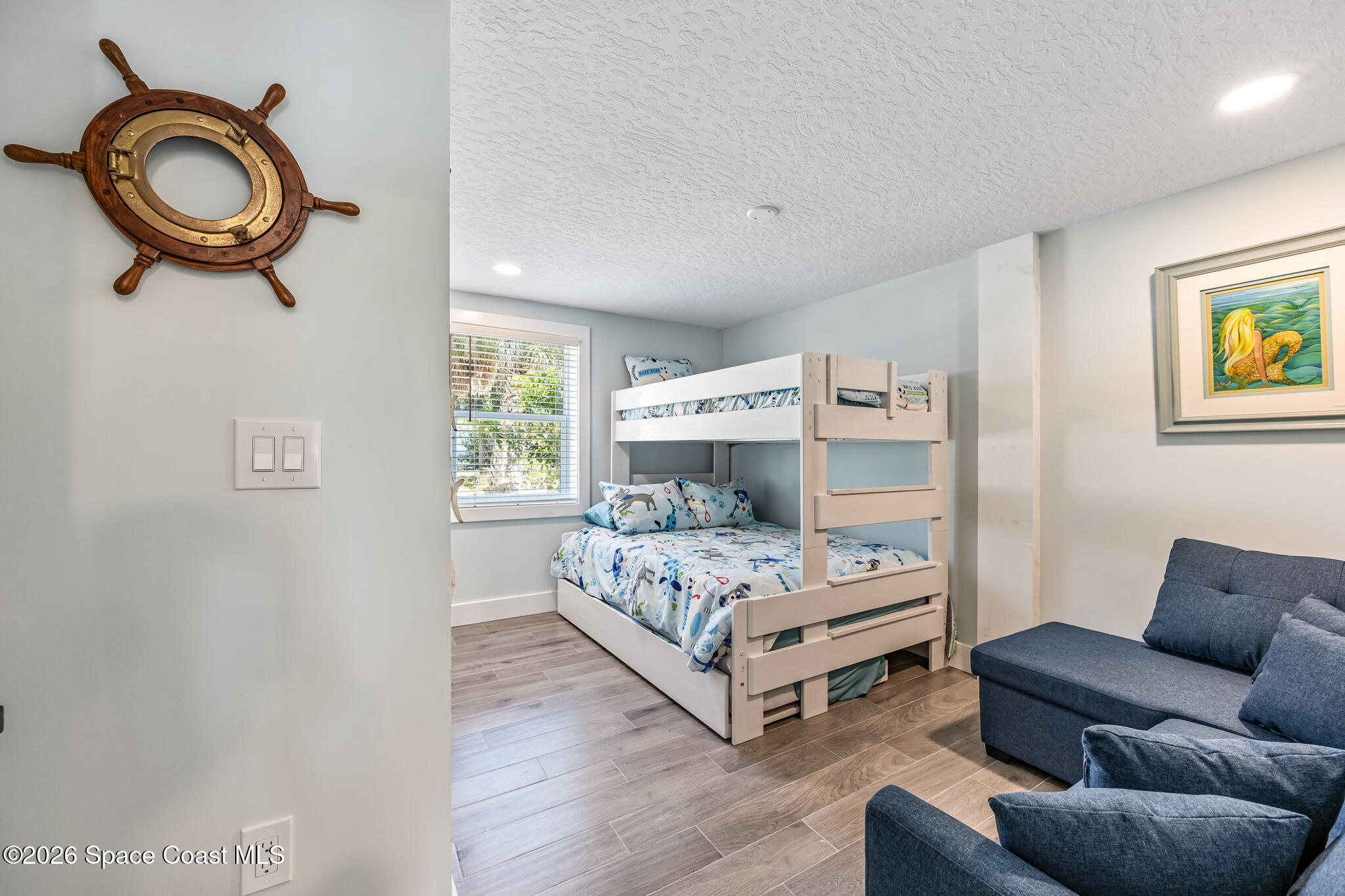 25 Vip Island, Unit A Grant, FL 32949 - Photo 27 of 56 a bedroom with a bed and a couch