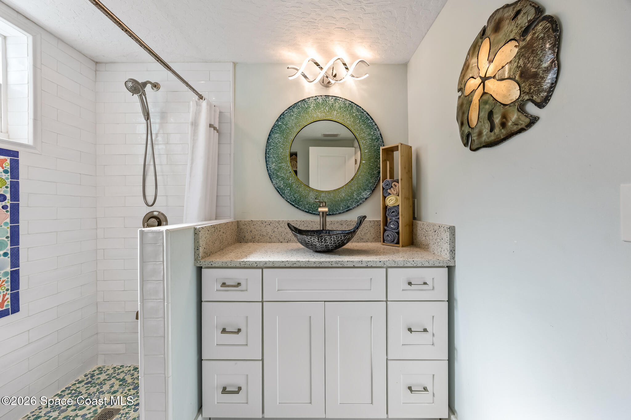 25 Vip Island, Unit A Grant, FL 32949 - Photo 28 of 56 a bathroom with a mirror and a sink