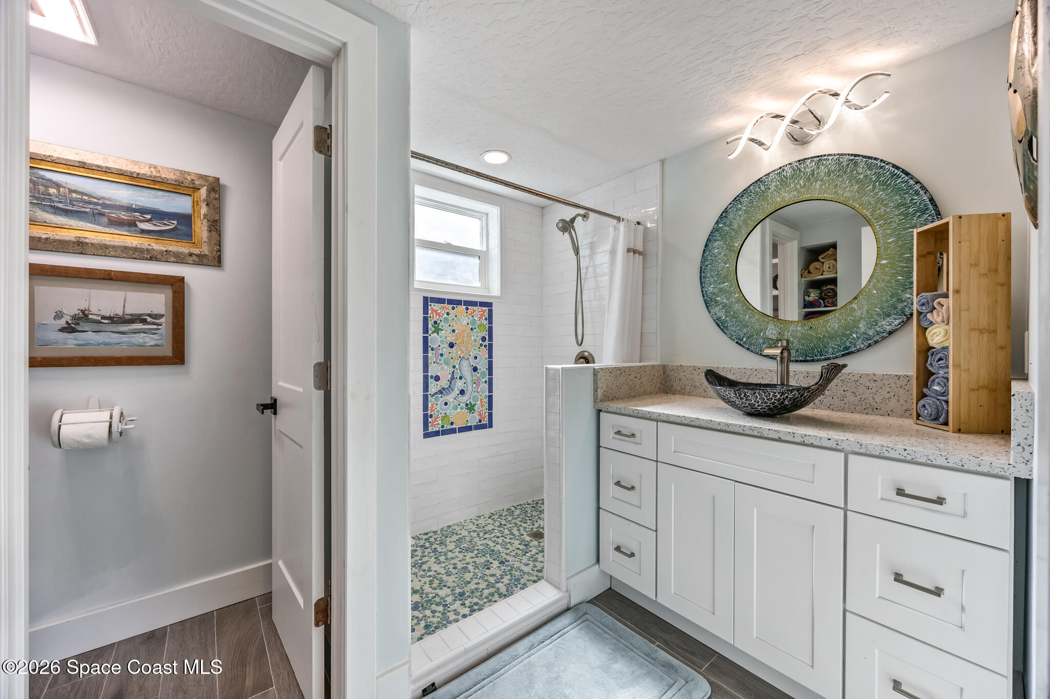 25 Vip Island, Unit A Grant, FL 32949 - Photo 29 of 56 a bathroom with a sink a mirror and shower