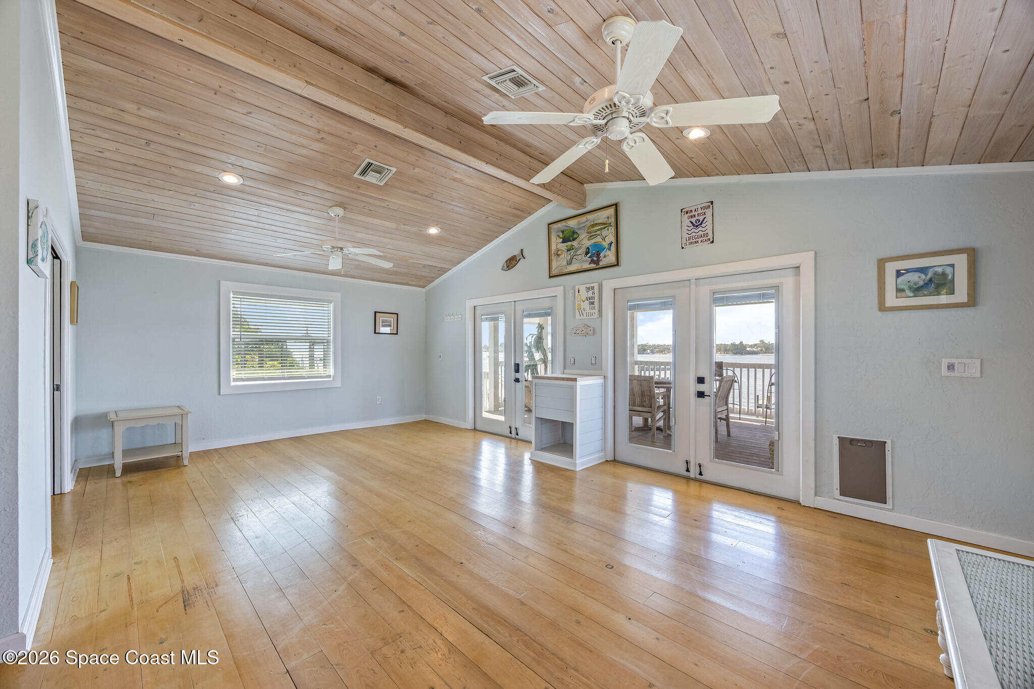 25 Vip Island, Unit A Grant, FL 32949 - Photo 10 of 56 a view of an empty room with wooden floor and a ceiling fan