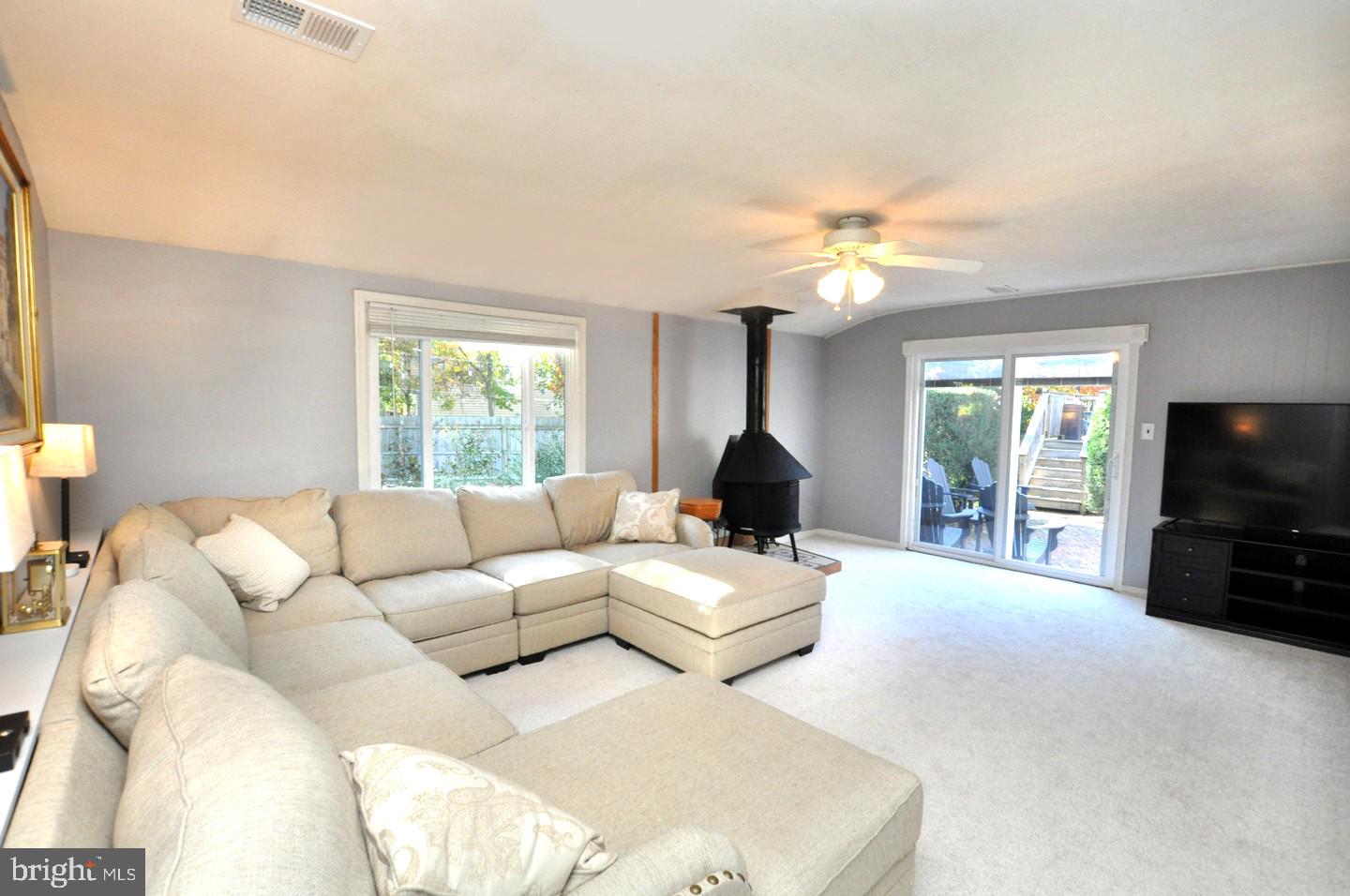 10 Blatherwick Drive Berlin, NJ 08009 - Photo 14 of 38 a living room with furniture a chandelier and a flat screen tv