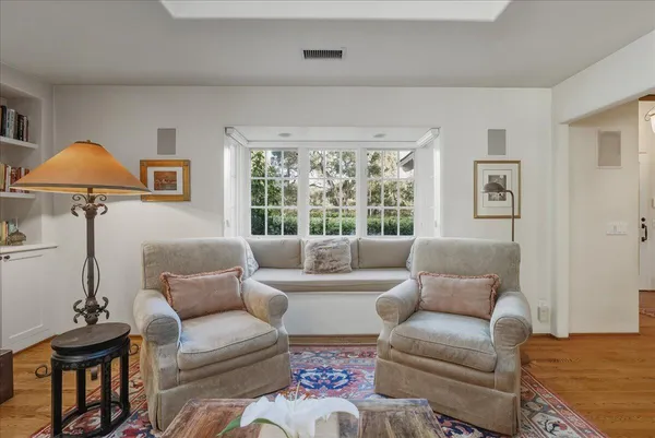 a living room with furniture and a lamp