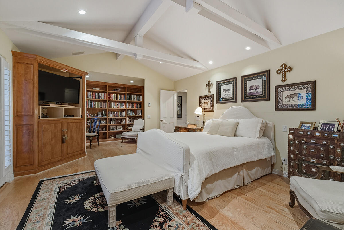 2140 Veloz Drive Montecito, CA 93108 - Photo 26 of 50 a spacious bedroom with a bed a table and bookshelf