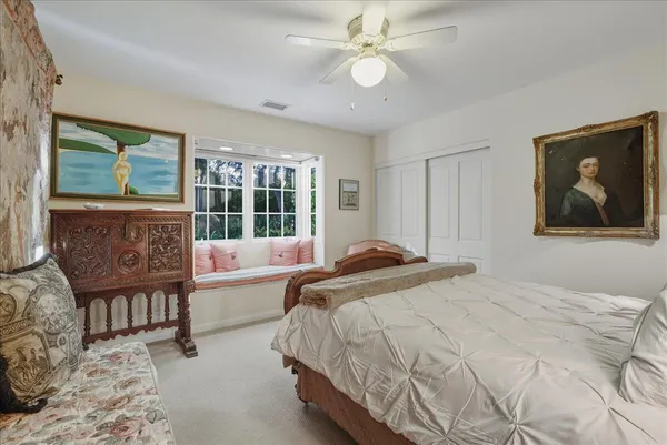 a spacious bedroom with a bed and a large window
