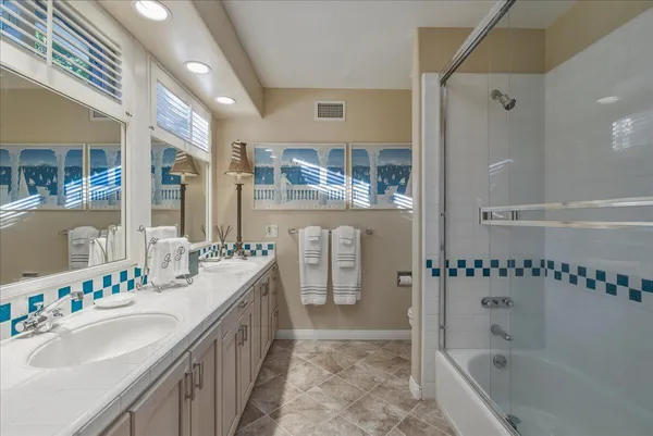 a bathroom with a tub sink and mirror