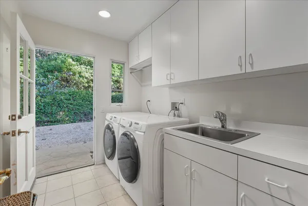 a utility room with sink dryer and washer
