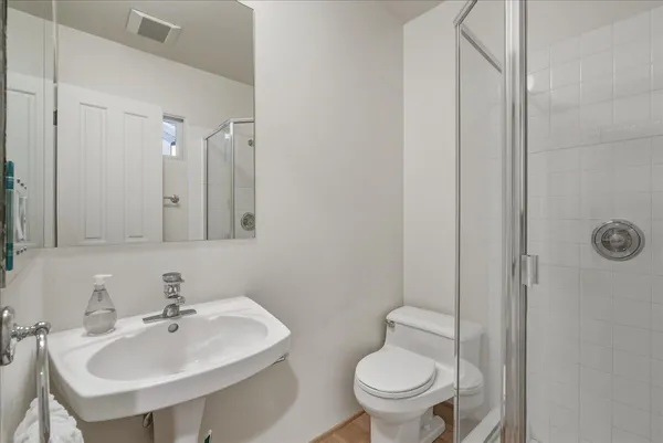 a bathroom with a sink toilet and a mirror