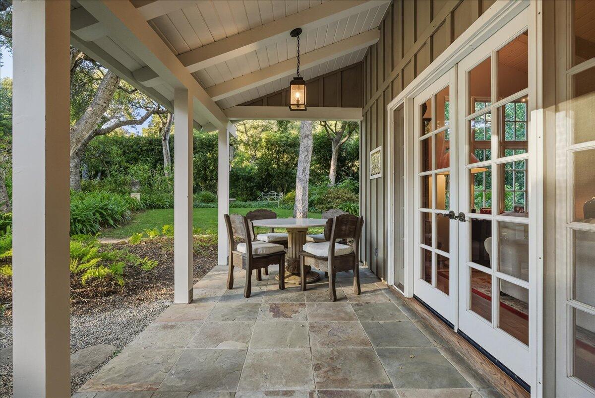 2140 Veloz Drive Montecito, CA 93108 - Photo 44 of 50 a view of a patio with table and chairs potted plants and floor to ceiling window