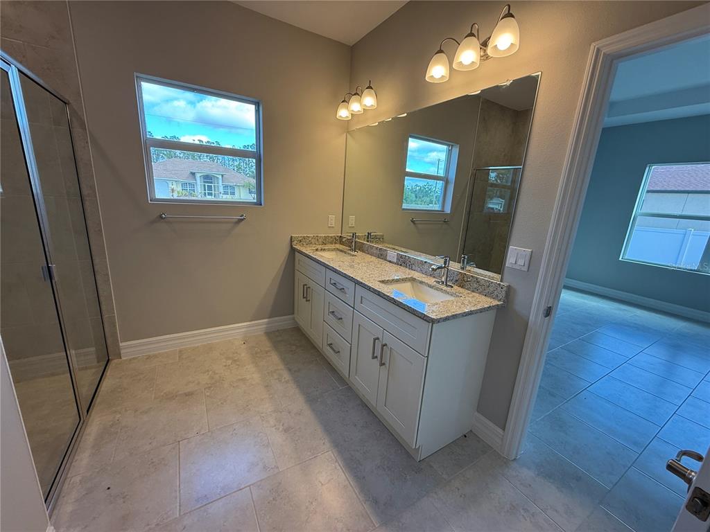 2268 Brewster Road North Port, FL 34288 - Photo 14 of 33 a bathroom with 2 sink and a mirror