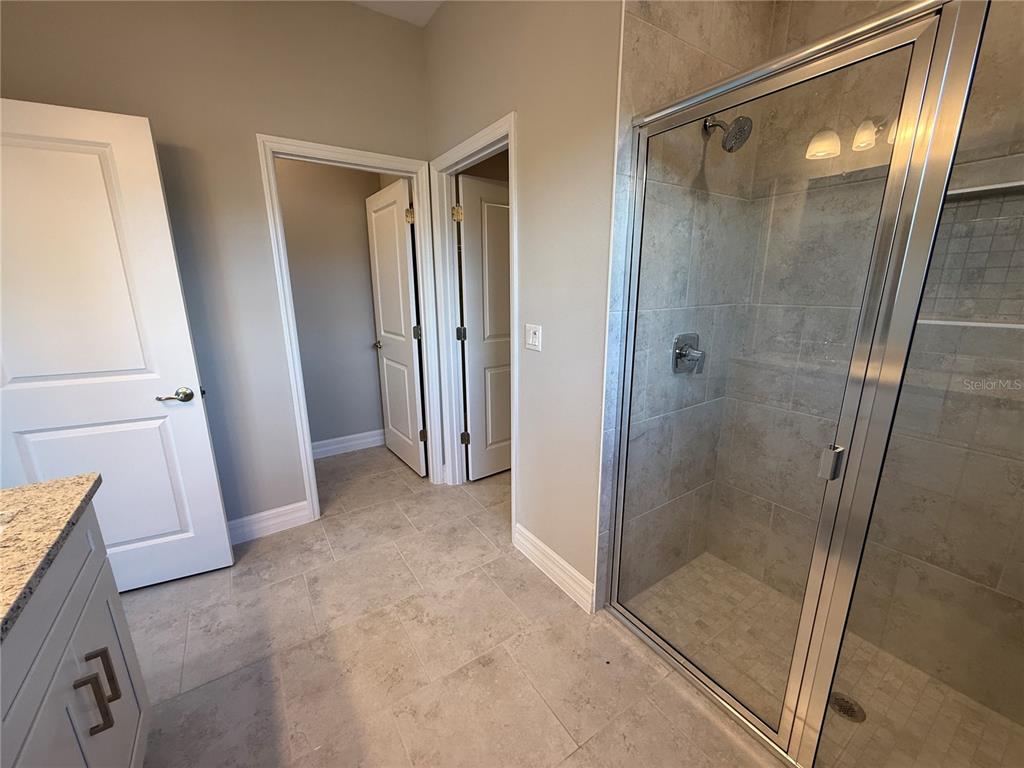 2268 Brewster Road North Port, FL 34288 - Photo 16 of 33 a bathroom with a glass door shower