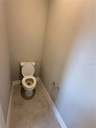 a white toilet sitting in a bathroom