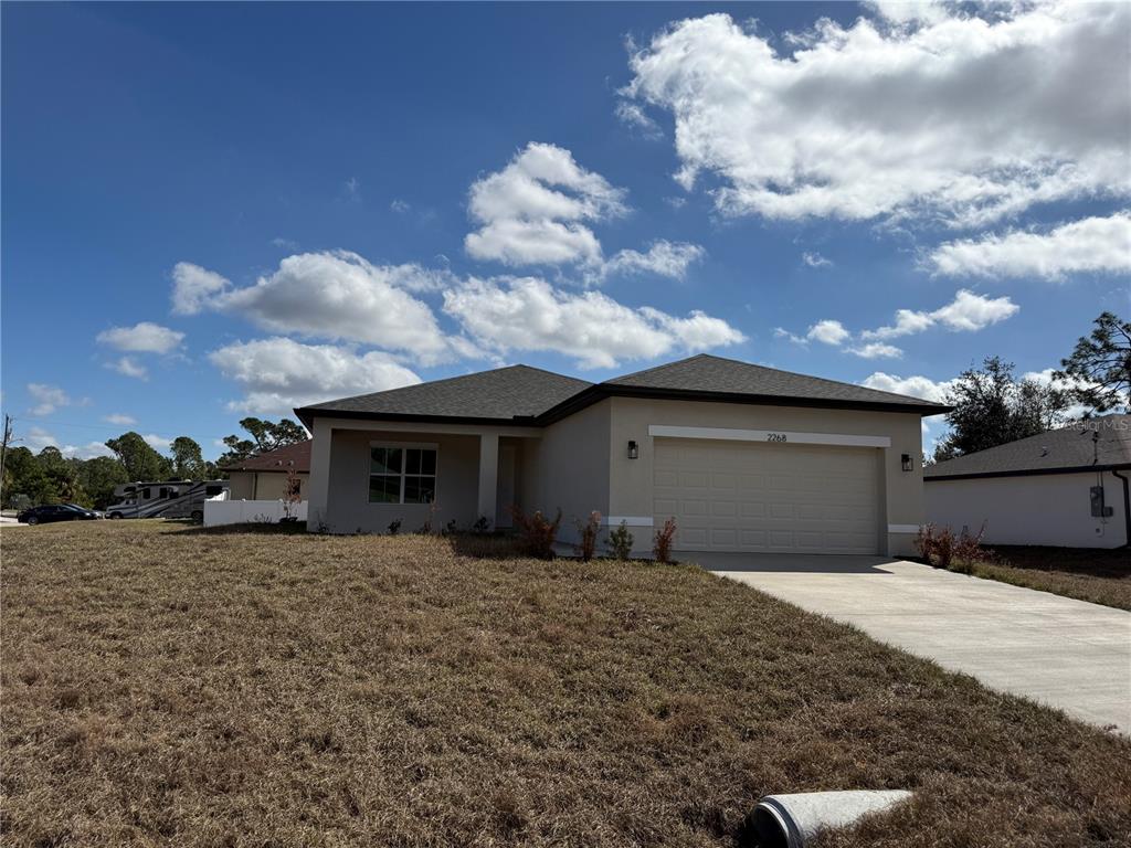 2268 Brewster Road North Port, FL 34288 - Photo 2 of 33 a front view of a house with a yard