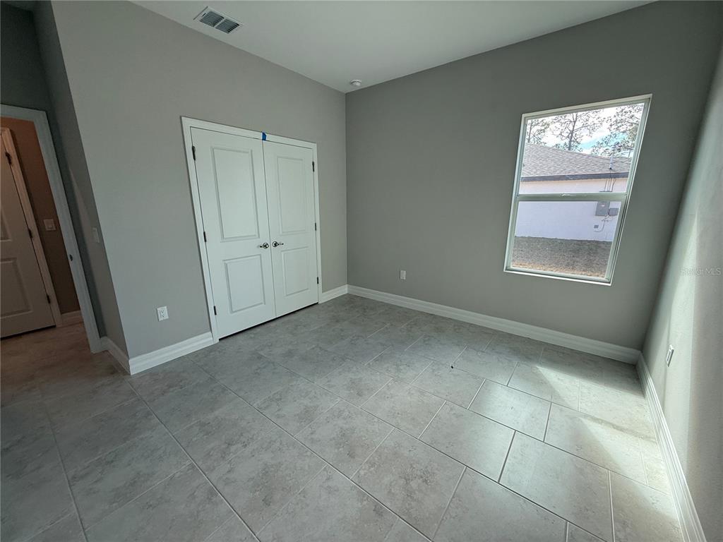 2268 Brewster Road North Port, FL 34288 - Photo 23 of 33 an empty room with windows and closet
