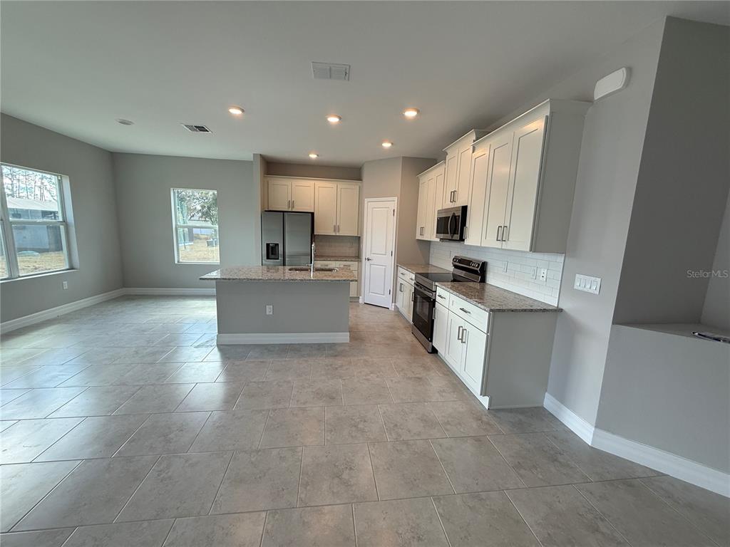 2268 Brewster Road North Port, FL 34288 - Photo 6 of 33 a large kitchen with cabinets and a stove top oven