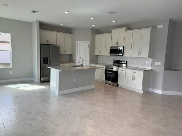 a kitchen with a stove a sink and a refrigerator