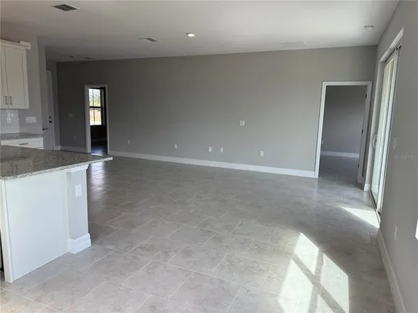 an empty room with mirror and entrance