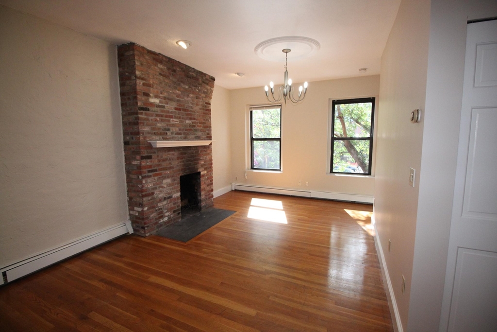 11 Worcester Street, Unit 2 Boston, MA 02118 - Photo 1 of 23 an empty room with wooden floor fireplace and windows