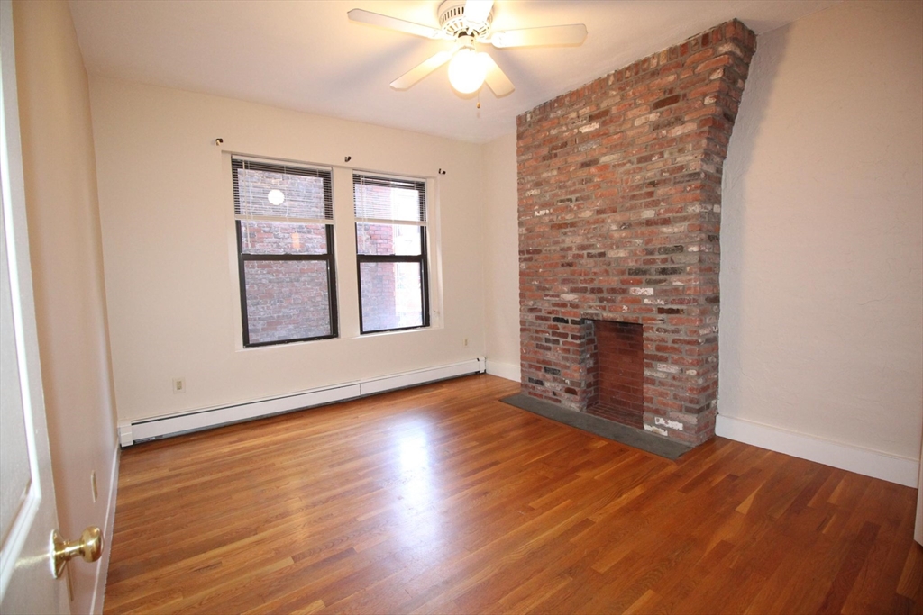 11 Worcester Street, Unit 2 Boston, MA 02118 - Photo 14 of 23 an empty room with wooden floor chandelier fan and windows