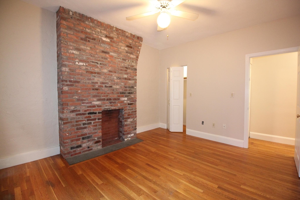 11 Worcester Street, Unit 2 Boston, MA 02118 - Photo 15 of 23 wooden floor in an empty room with a fireplace