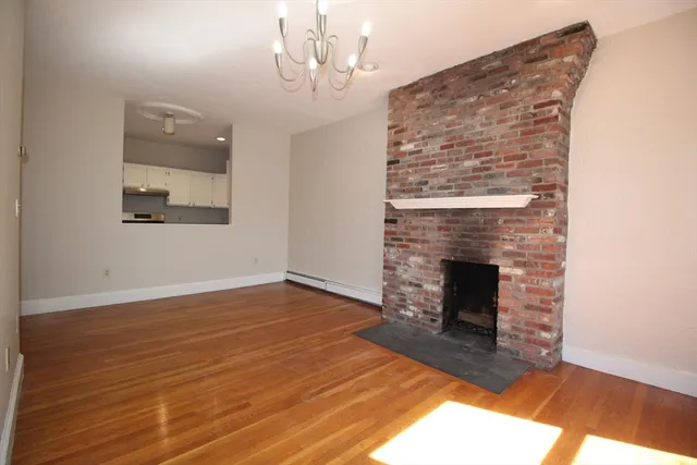 a view of an empty room and fire place